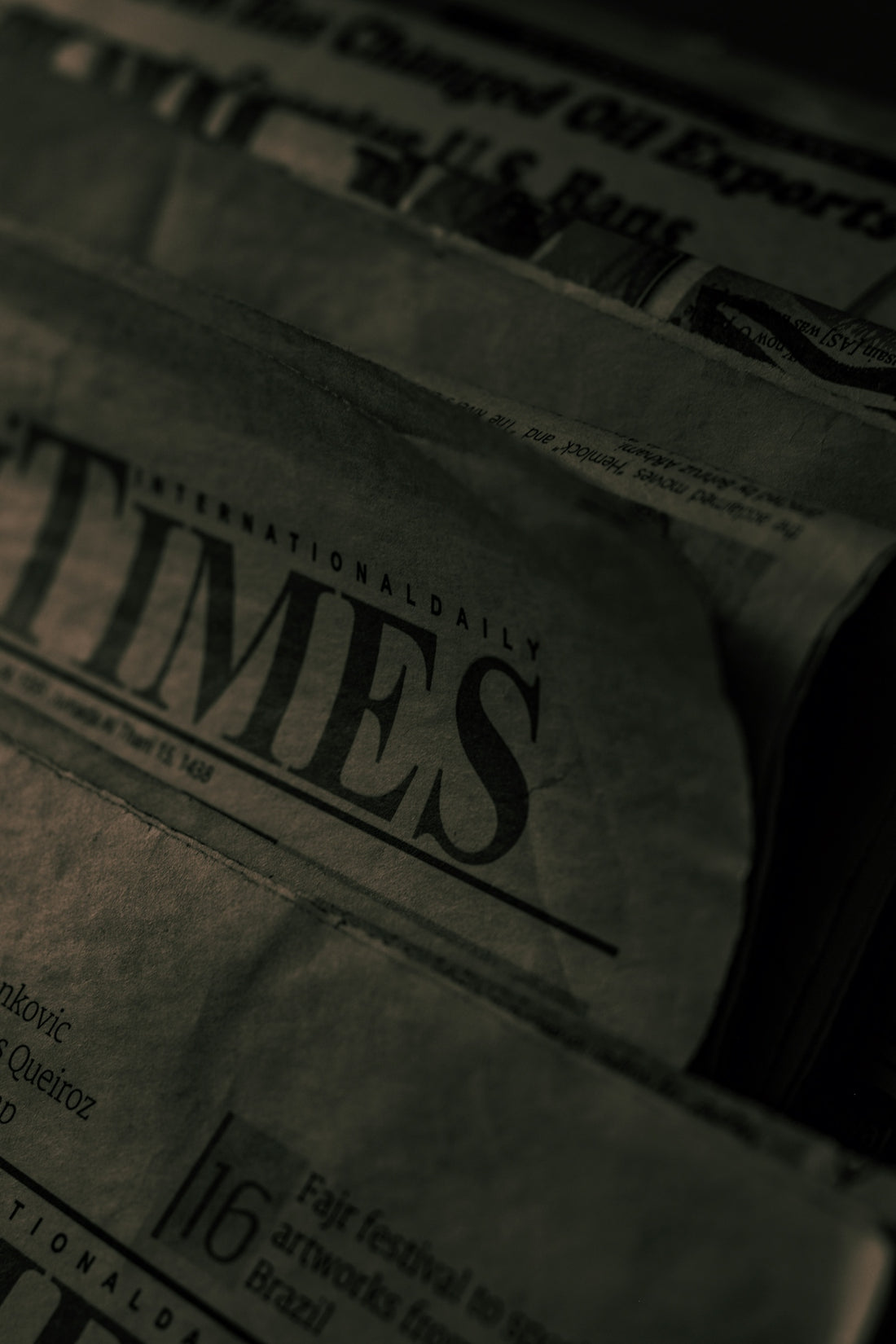 newspapers stacked on top of each other on a table