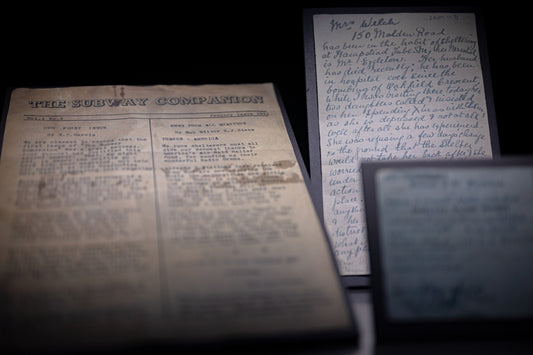 Old documents displayed in dim lighting.
